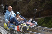 father and daughter riding Pigeon Forge Racing Coaster