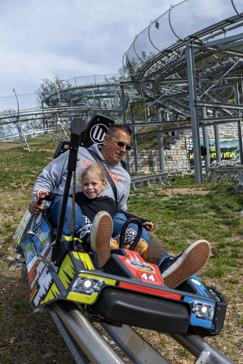 Dad and daughter riding the Pigeon Forge Racing Coaster